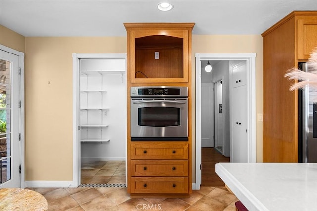1539 Hammon Ave, Oroville, CA 95966 - kitchen with oven, light countertops, baseboards, recessed lighting, and light tile patterned flooring
