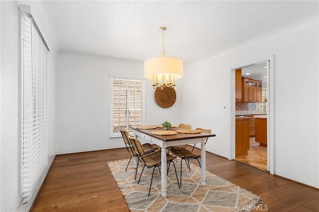 1539 Hammon Ave, Oroville, CA 95966 - dining room featuring plenty of natural light, light wood-style flooring, and a chandelier