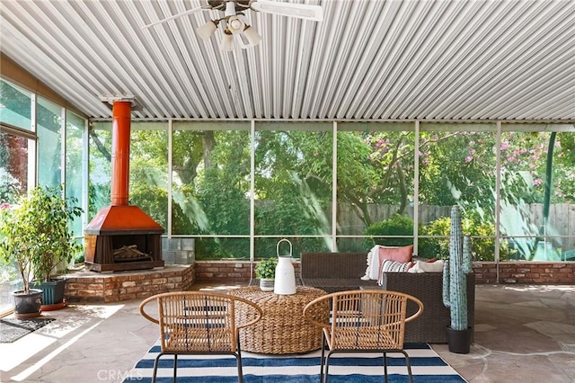 1539 Hammon Ave, Oroville, CA 95966 - sunroom featuring a ceiling fan, an outdoor living space with a fireplace, and a wood stove