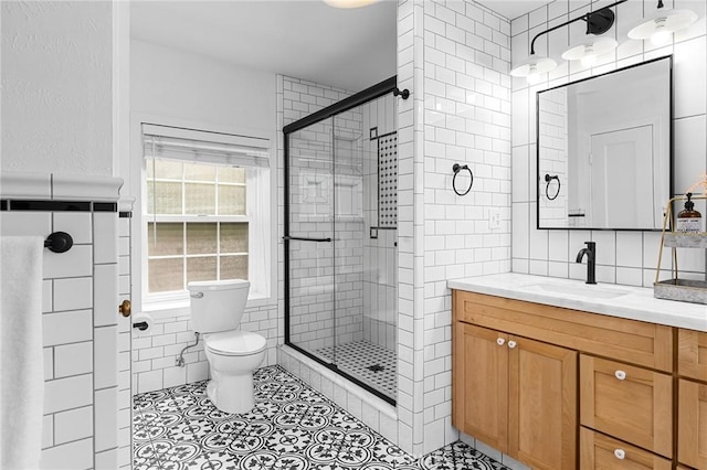 1539 Hammon Ave, Oroville, CA 95966 - full bathroom featuring tile walls, toilet, a shower stall, vanity, and tile patterned floors