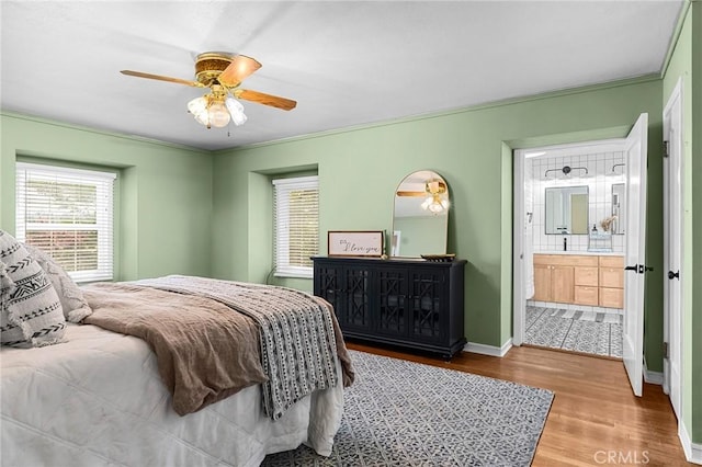 1539 Hammon Ave, Oroville, CA 95966 - bedroom with wood finished floors, connected bathroom, baseboards, ornamental molding, and a ceiling fan