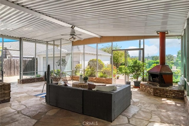 1539 Hammon Ave, Oroville, CA 95966 - sunroom / solarium featuring a wood stove, ceiling fan, an outdoor living space, and lofted ceiling
