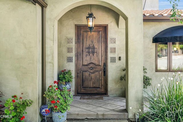 171 N Sunset Pl, Monrovia, CA 91016 - view of exterior entry with stucco siding and a tiled roof