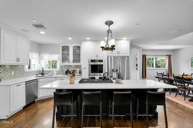 171 N Sunset Pl, Monrovia, CA 91016 - kitchen with stainless steel appliances, a kitchen breakfast bar, white cabinets, light countertops, and recessed lighting