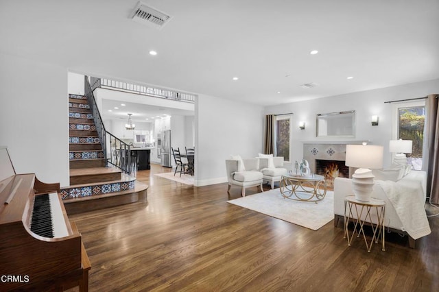 171 N Sunset Pl, Monrovia, CA 91016 - living room with stairs, wood finished floors, a fireplace, recessed lighting, and a chandelier