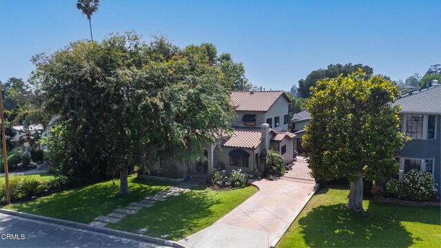171 N Sunset Pl, Monrovia, CA 91016 - view of front of house with driveway, a front yard, a tile roof, and stucco siding