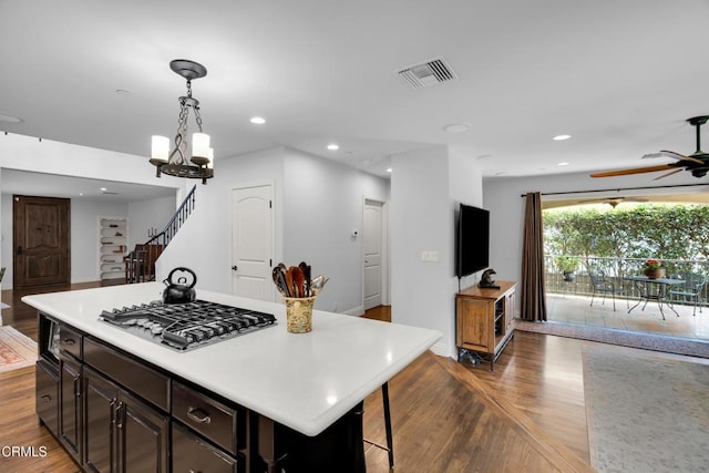 171 N Sunset Pl, Monrovia, CA 91016 - kitchen with light countertops, a chandelier, wood finished floors, stainless steel gas cooktop, and ceiling fan