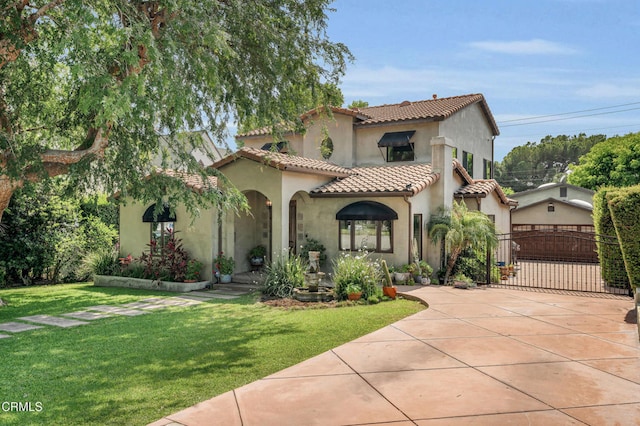 171 N Sunset Pl, Monrovia, CA 91016 - mediterranean / spanish-style home featuring stucco siding, concrete driveway, a tiled roof, a front lawn, and a gate
