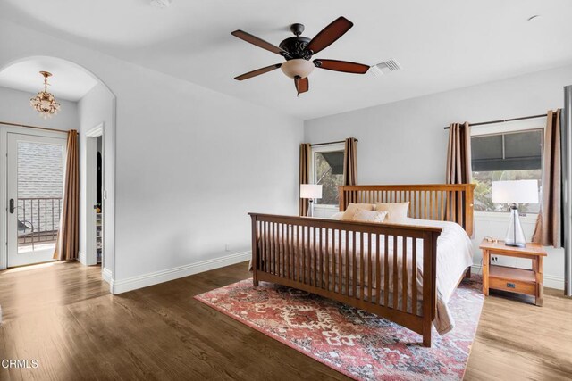171 N Sunset Pl, Monrovia, CA 91016 - bedroom featuring wood finished floors, access to outside, arched walkways, and a chandelier