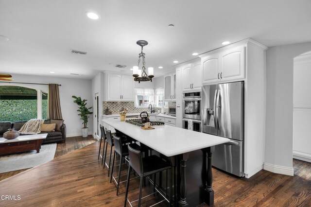 171 N Sunset Pl, Monrovia, CA 91016 - kitchen featuring appliances with stainless steel finishes, healthy amount of natural light, white cabinets, recessed lighting, and backsplash