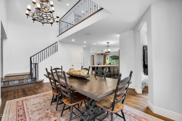 171 N Sunset Pl, Monrovia, CA 91016 - dining space with a chandelier, wood finished floors, arched walkways, stairs, and recessed lighting