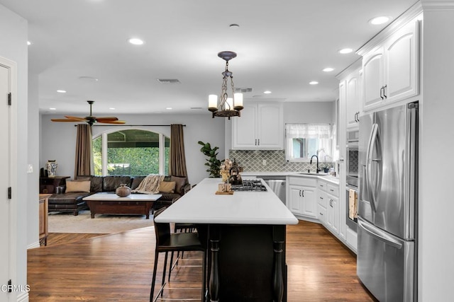 171 N Sunset Pl, Monrovia, CA 91016 - kitchen featuring freestanding refrigerator, a kitchen breakfast bar, white cabinetry, healthy amount of natural light, and recessed lighting