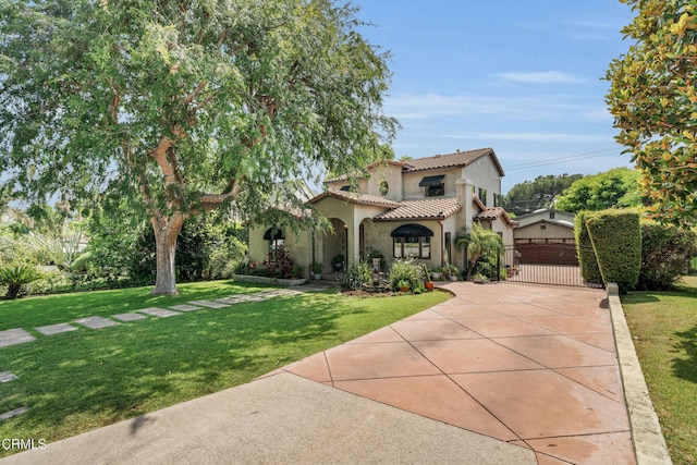171 N Sunset Pl, Monrovia, CA 91016 - mediterranean / spanish house featuring a tiled roof, stucco siding, driveway, a front lawn, and an attached garage