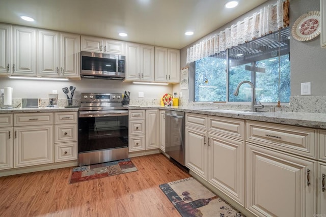 8516 Valley View Trl, Pine Valley, CA 91962 - kitchen with stainless steel appliances, a sink, light wood-type flooring, light stone countertops, and recessed lighting