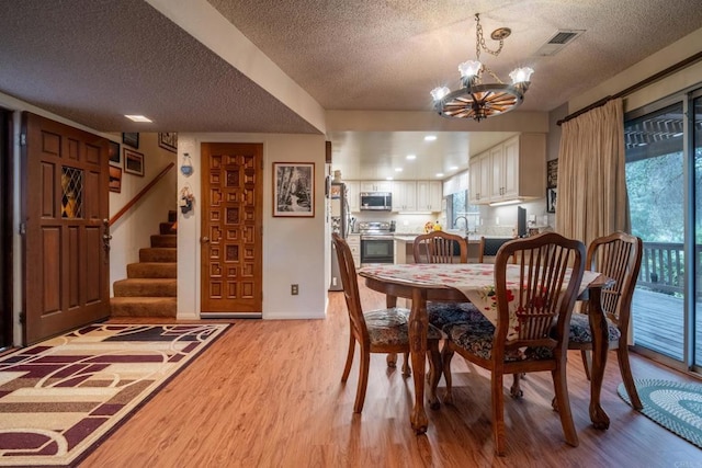 8516 Valley View Trl, Pine Valley, CA 91962 - dining space with a textured ceiling, a chandelier, light wood-style flooring, and plenty of natural light