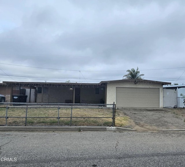 374 Will Ave, Oxnard, CA 93036 - single story home with dirt driveway, an attached garage, and stucco siding