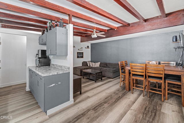 374 Will Ave, Oxnard, CA 93036 - kitchen with gray cabinets, ceiling fan, light wood-style flooring, light countertops, and beamed ceiling