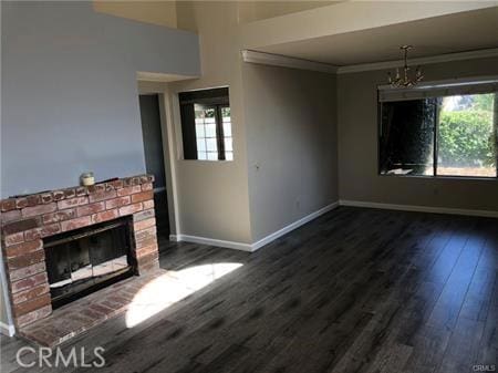 3249 Cambridge Dr, Chino Hills, CA 91709 - unfurnished living room with baseboards, wood finished floors, a brick fireplace, a chandelier, and ornamental molding