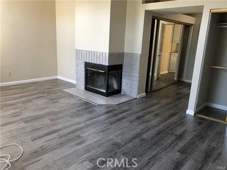 3249 Cambridge Dr, Chino Hills, CA 91709 - unfurnished living room featuring baseboards, dark wood finished floors, and a brick fireplace