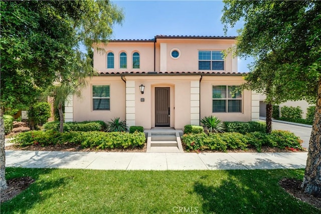 102 Anthology, Irvine, CA 92618 - mediterranean / spanish-style house with stucco siding, a tiled roof, and a front lawn