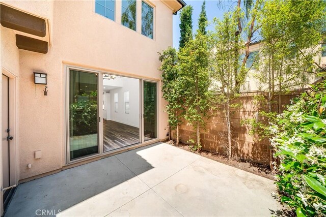 102 Anthology, Irvine, CA 92618 - doorway to property featuring a patio and stucco siding