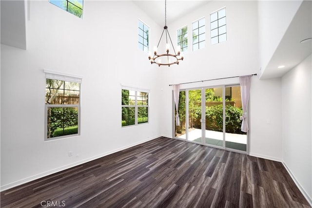 102 Anthology, Irvine, CA 92618 - spare room with dark wood-style floors, healthy amount of natural light, a chandelier, a high ceiling, and baseboards