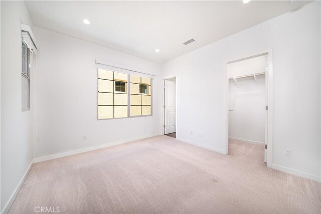 102 Anthology, Irvine, CA 92618 - unfurnished bedroom featuring carpet floors, baseboards, a walk in closet, and recessed lighting