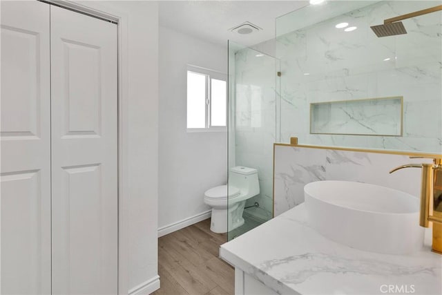 7495 Balsa Ave, Yucca Valley, CA 92284 - bathroom with a marble finish shower, a closet, wood finished floors, and vanity