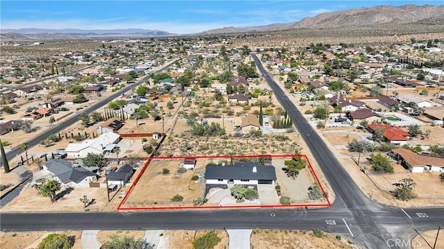 7495 Balsa Ave, Yucca Valley, CA 92284 - aerial view of residential area featuring property boundaries highlighted and a mountain backdrop