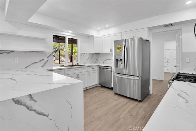 7495 Balsa Ave, Yucca Valley, CA 92284 - kitchen with stainless steel appliances, open shelves, white cabinetry, light stone counters, and recessed lighting