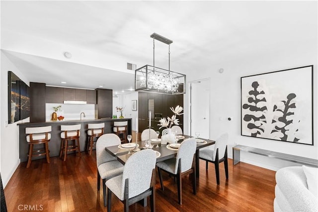 6250 Hollywood Blvd Unit 7G, Los Angeles, CA 90028 - dining area featuring wood-type flooring, a chandelier, and baseboards