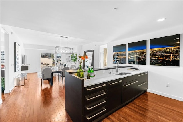 6250 Hollywood Blvd Unit 7G, Los Angeles, CA 90028 - kitchen with a sink, dark cabinetry, dark wood finished floors, and baseboards