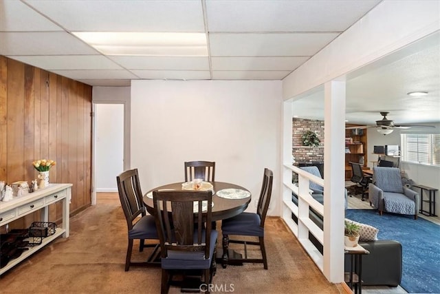809 San Marino Ave, Montebello, CA 90640 - carpeted dining area with wooden walls, a paneled ceiling, and ceiling fan