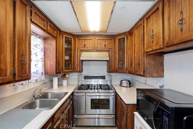 809 San Marino Ave, Montebello, CA 90640 - kitchen featuring double oven range, under cabinet range hood, a sink, brown cabinetry, and black microwave