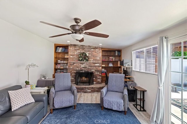 809 San Marino Ave, Montebello, CA 90640 - living room with ceiling fan, wood finished floors, and a brick fireplace