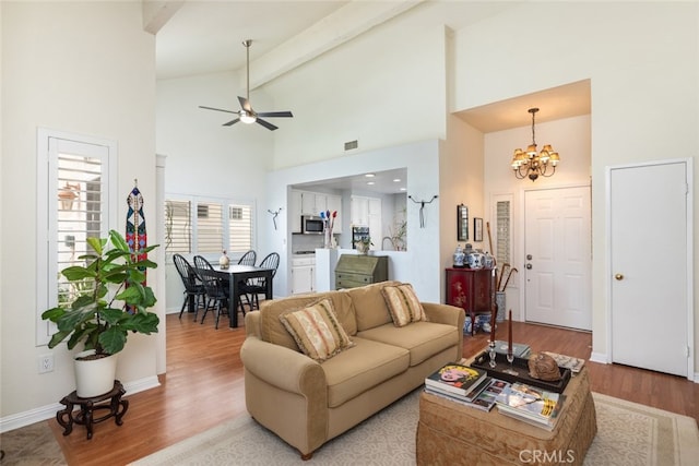 40280 Mimulus Way, Temecula, CA 92591 - living area with high vaulted ceiling, a chandelier, beam ceiling, a ceiling fan, and wood finished floors