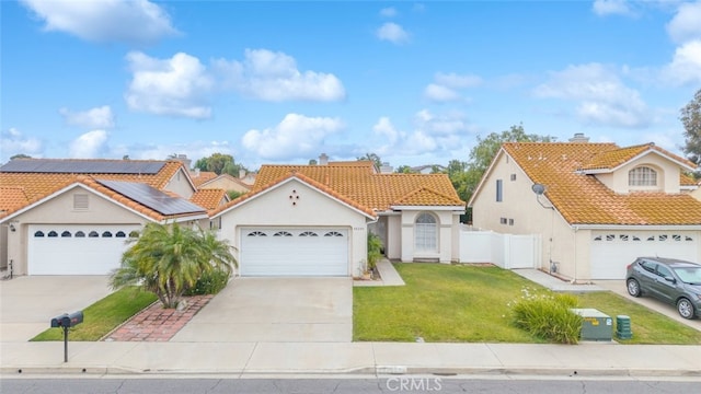 40280 Mimulus Way, Temecula, CA 92591 - view of front of house featuring a tile roof, stucco siding, concrete driveway, roof mounted solar panels, and an attached garage