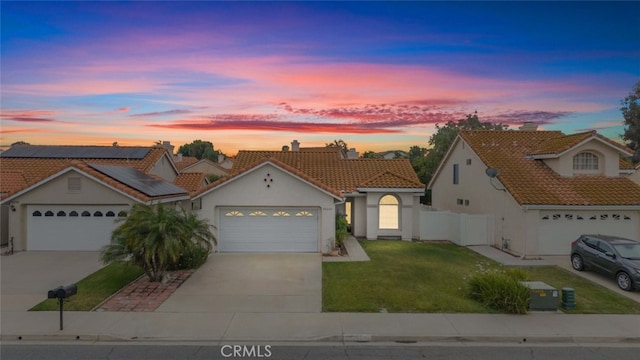 40280 Mimulus Way, Temecula, CA 92591 - mediterranean / spanish-style house with concrete driveway, solar panels, a tiled roof, stucco siding, and an attached garage