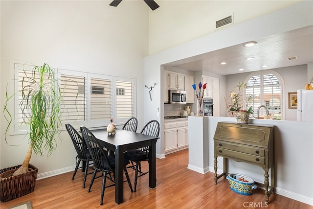 40280 Mimulus Way, Temecula, CA 92591 - dining area with light wood finished floors, a ceiling fan, baseboards, recessed lighting, and a high ceiling