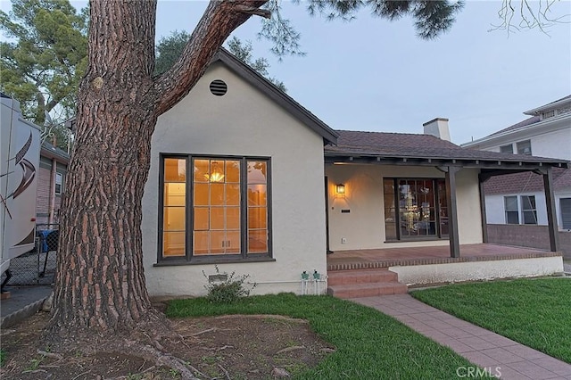550 N 1st Ave, Upland, CA 91786 - rear view of house with stucco siding, a yard, roof with shingles, and a chimney