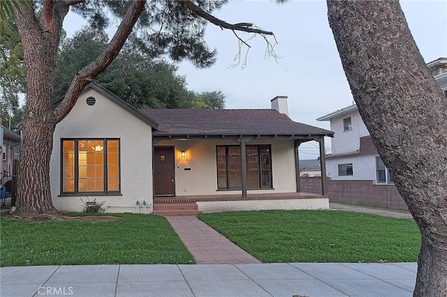 550 N 1st Ave, Upland, CA 91786 - ranch-style house with stucco siding, a shingled roof, a front lawn, and a porch