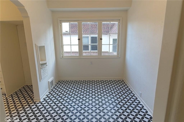 550 N 1st Ave, Upland, CA 91786 - unfurnished room featuring arched walkways, baseboards, and tile patterned floors