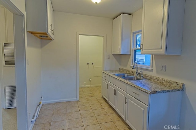 550 N 1st Ave, Upland, CA 91786 - kitchen featuring a sink, white cabinets, light tile patterned flooring, and baseboards
