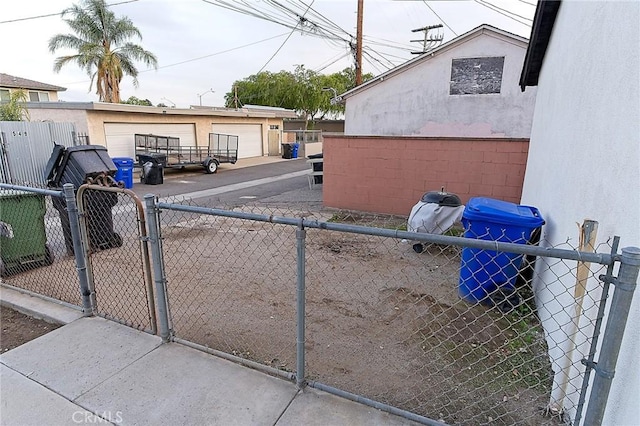 550 N 1st Ave, Upland, CA 91786 - view of side of home with stucco siding, a gate, a detached garage, and an outbuilding