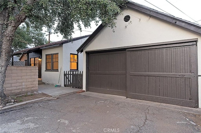 550 N 1st Ave, Upland, CA 91786 - view of front of property with stucco siding and a garage