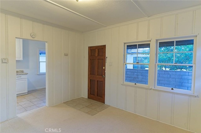 550 N 1st Ave, Upland, CA 91786 - entryway featuring light carpet, a decorative wall, and light tile patterned floors