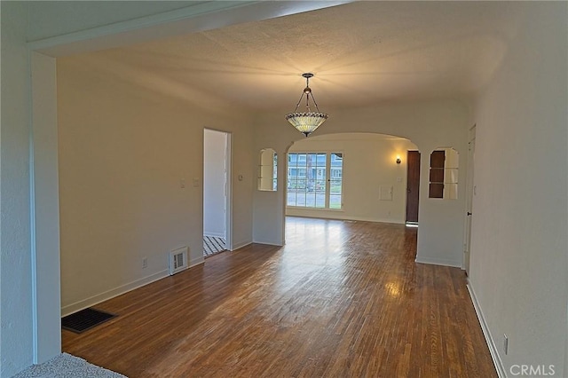 550 N 1st Ave, Upland, CA 91786 - spare room featuring arched walkways, wood finished floors, and baseboards