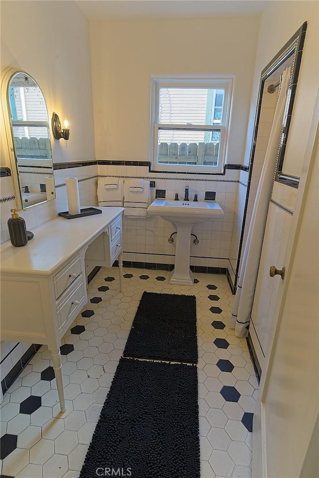 550 N 1st Ave, Upland, CA 91786 - bathroom featuring tile patterned flooring, plenty of natural light, tile walls, and a wainscoted wall