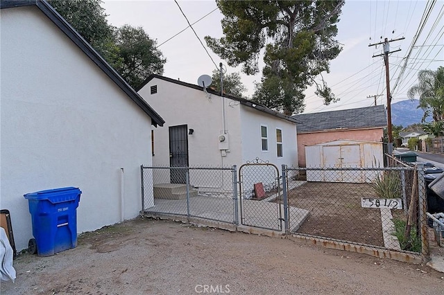 550 N 1st Ave, Upland, CA 91786 - view of side of property with a gate and stucco siding