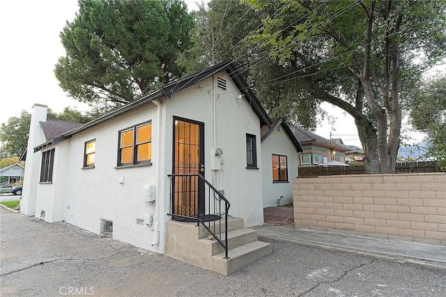 550 N 1st Ave, Upland, CA 91786 - view of front facade with stucco siding and a chimney